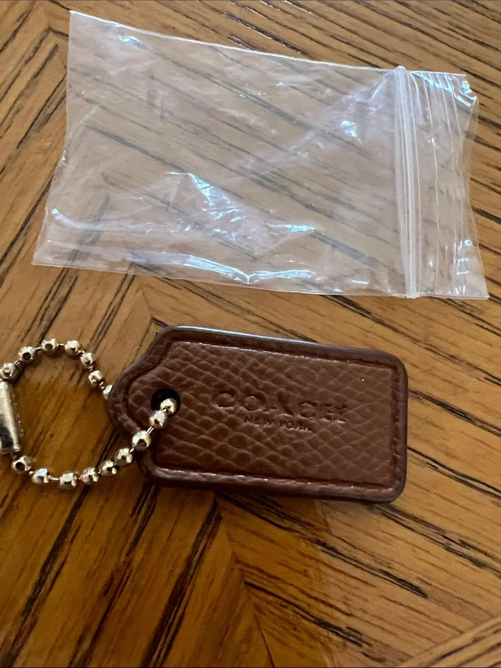 Coach Brown Pebbled Leather Key Tag with gold Bead Chain